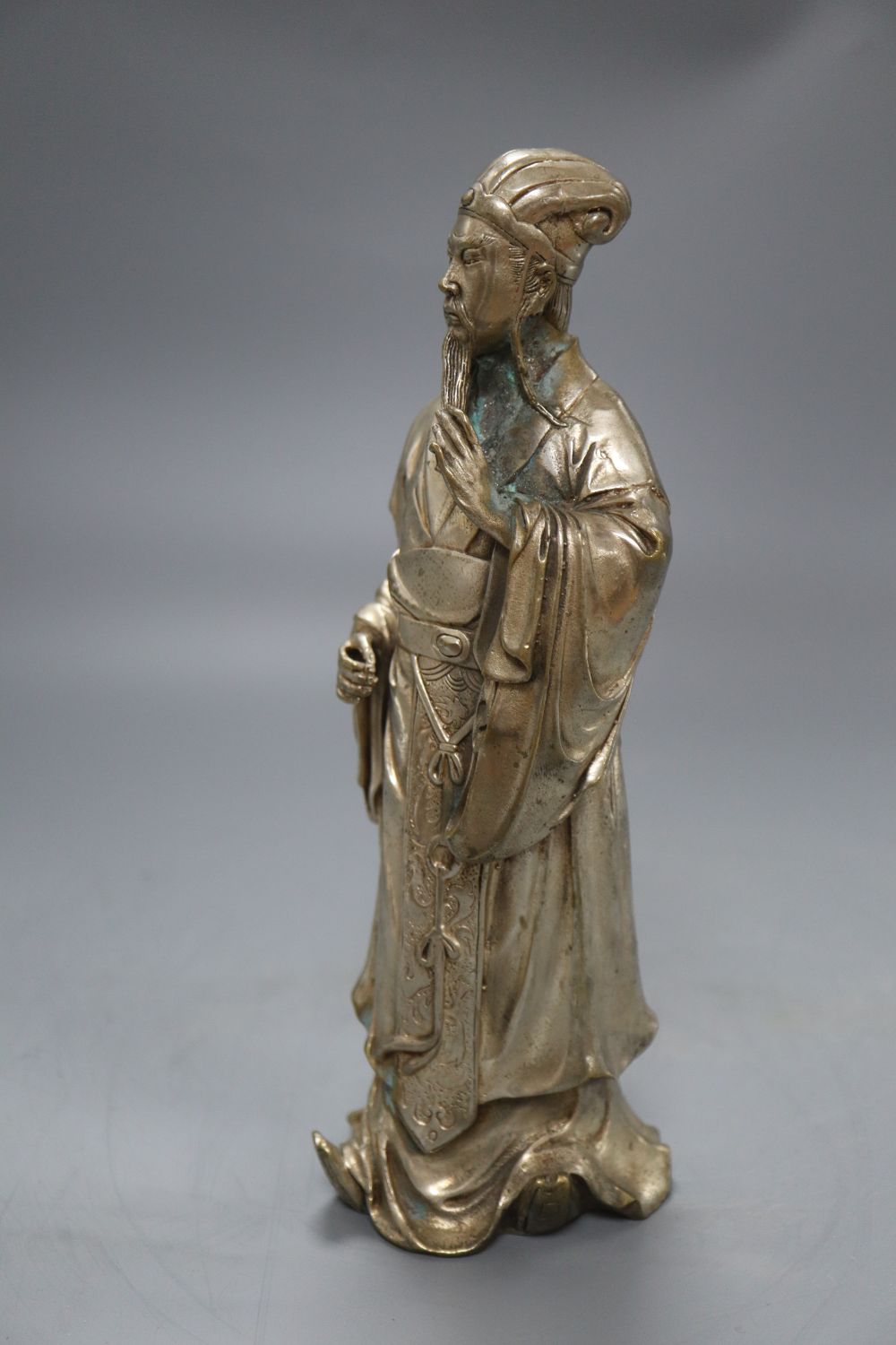 A Chinese silvered metal figure of an elder, height 24cm